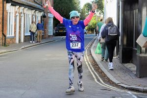Albion fan Tracey Page is about to hit her goal as she approaches the finish.