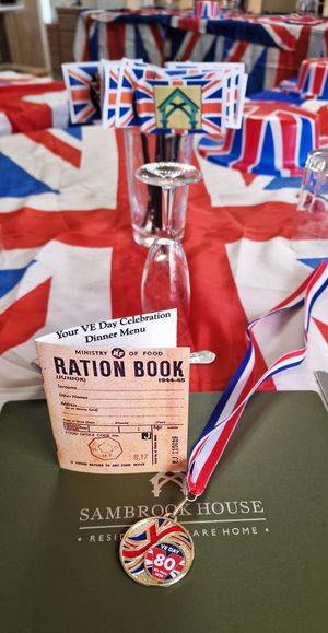 Place setting with Ration Book menu & Commemorative Medal