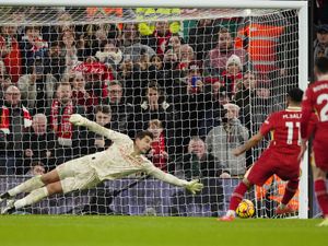 Mohamed Salah fires a penalty with his left foot into the bottom corner