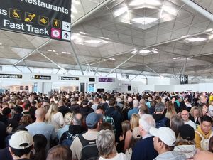 Passengers at Stansted Airport waiting for updates after an IT malfunction caused disruption and delays