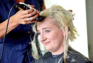 Olivia Bolas having her head shaved