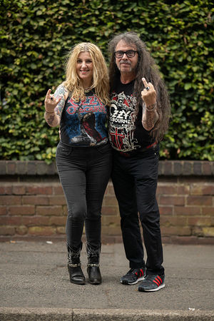 Music fans Silvia Gracia (L) and Paco Gracia (R) arrive to attend British rock band Black Sabbath's "Back to The Beginning" concert, Ozzy Osbourne's final ever gig as Black Sabbath's frontman at Villa Park in Birmingham, central England on July 5, 2025. Osbourne, who revealed in 2020 that he has Parkinson's disease, will join Tony Iommi, Geezer Butler and Bill Ward for the all-day "Back To The Beginning" show in Birmingham, central England, where the heavy metal giants formed in 1968. (Photo by Oli SCARFF / AFP) (Photo by OLI SCARFF/AFP via Getty Images)          