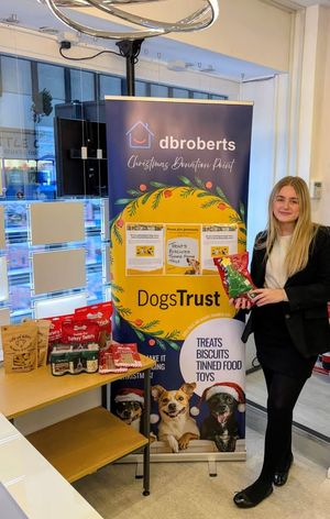 DB Roberts Apprentice, Alex Gregory with the DogsTrust Donation Table in DB Roberts Shrewsbury Office 