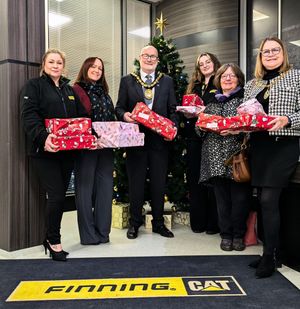 Photo Caption: Steve Thornley, Chair of Cannock Chase Council and Heather Preece from West Chadsmoor Family Centre visited the Finning headquarters to offer their thanks for the company's generous donation.