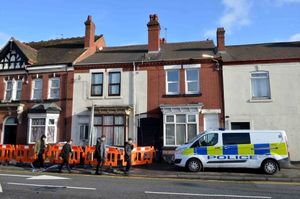 Police outside the house in Cinder Bank, Netherton