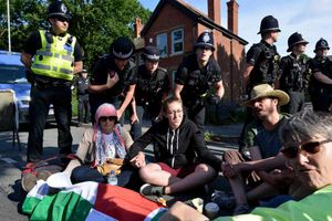 Protesters sit outside UaV Engines factory in Shenstone in July
