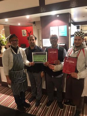 Owner Mohammed Uddin, pictured middle right, with staff at Raj Cuisine