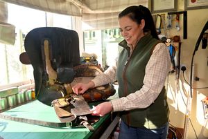 Kate restoring a vintage saddle in her workshop